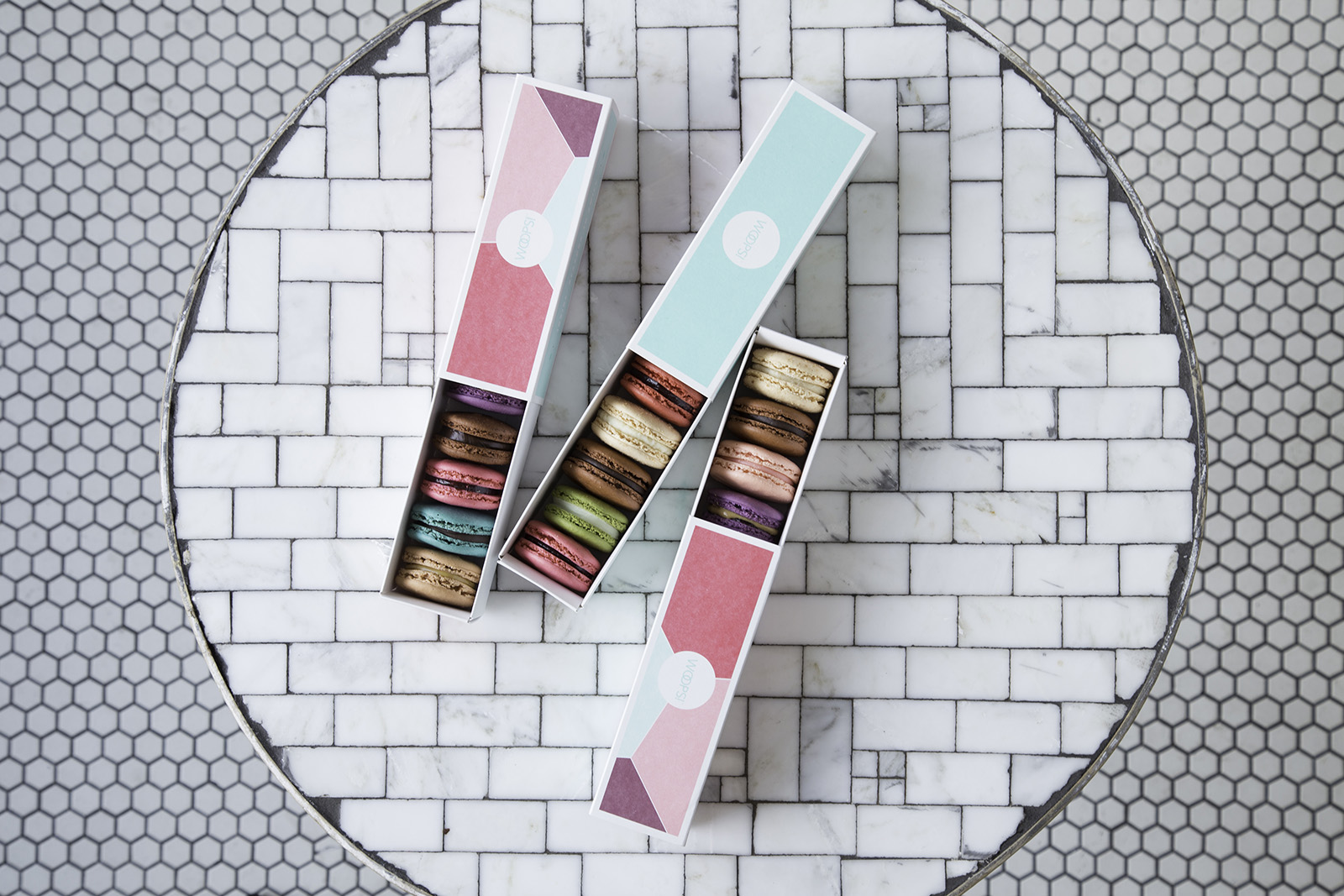 macaron cookies in boxes stacked next to each other