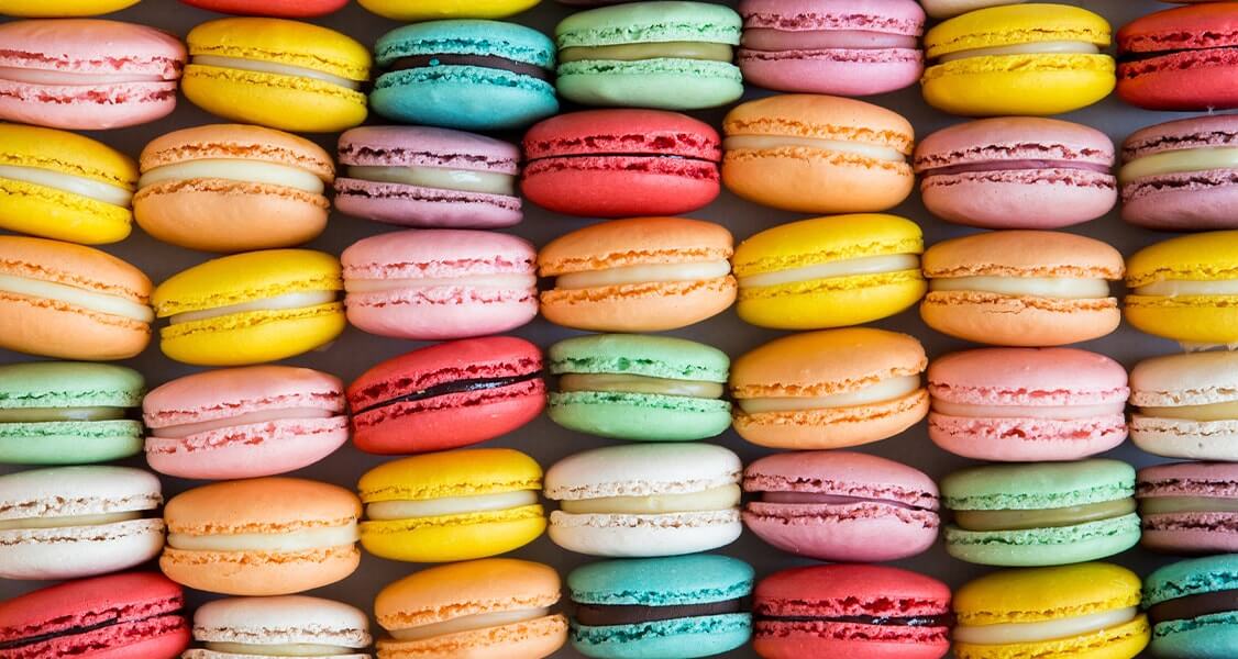 Numerous assorted French macarons.