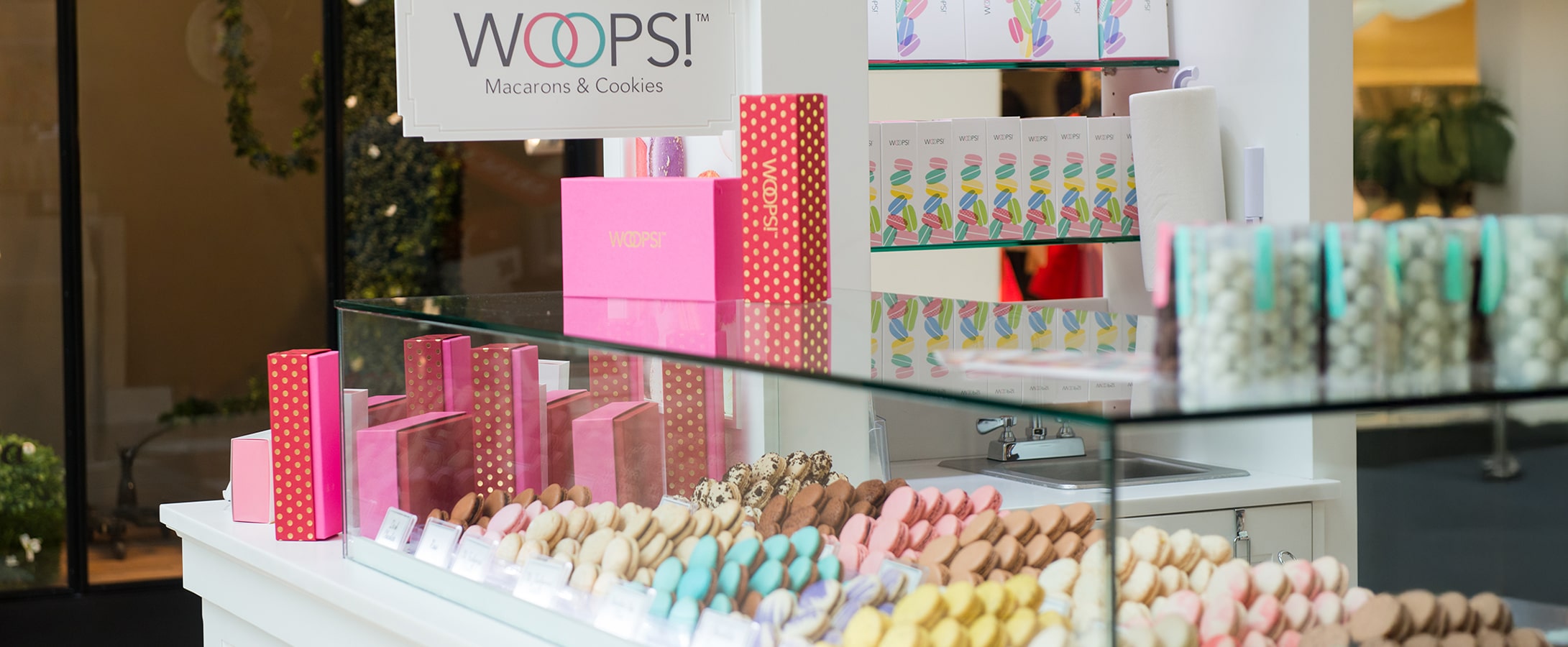 Woops! kiosk in a mall, with coloful macarons.